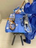 The Cord Management Drape placed on a mayo stand with various surgical cords stored within it and not tangled.