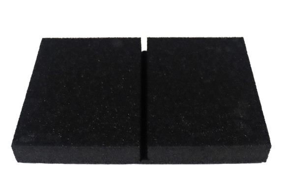 A black rectangular polyethylene foam bock with a cut in the middle to hold an x-ray cassette.